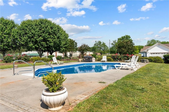 view of swimming pool featuring a fenced in pool, fence, a lawn, and a patio area