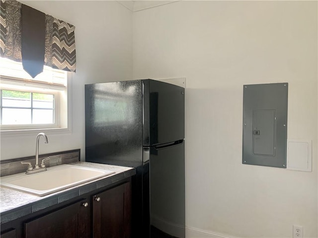 204 Rock Creek Rd, Anderson, SC 29625 - kitchen with electric panel, a sink, freestanding refrigerator, and dark brown cabinets