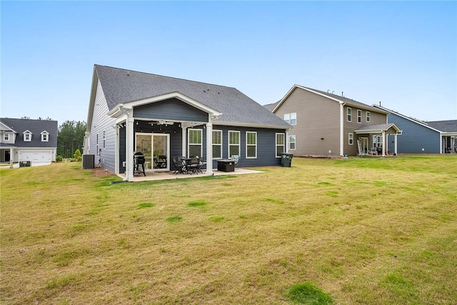 rear view of property with a yard, a patio, central AC, and a ceiling fan