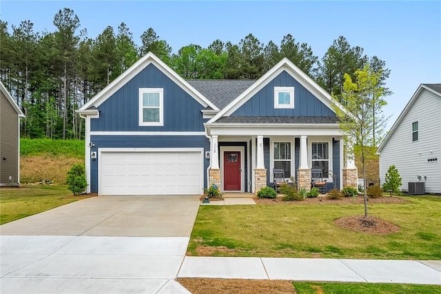 craftsman house featuring an attached garage, board and batten siding, a front yard, and a porch