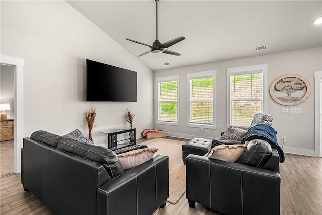 living area with a wealth of natural light, light wood-style flooring, ceiling fan, and visible vents