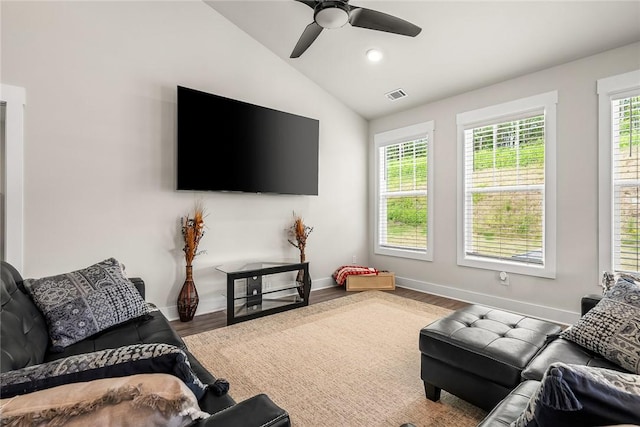 living room with ceiling fan, baseboards, wood finished floors, vaulted ceiling, and visible vents