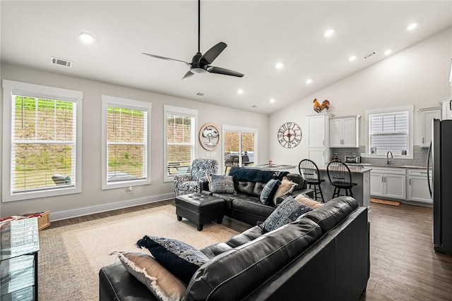 living room with visible vents, recessed lighting, a ceiling fan, and a healthy amount of sunlight