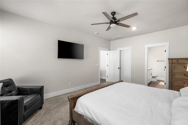 carpeted bedroom featuring connected bathroom, baseboards, visible vents, and ceiling fan