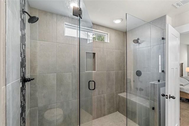 bathroom featuring ensuite bathroom, a stall shower, and visible vents