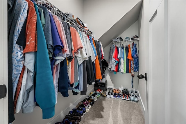 spacious closet featuring carpet flooring and lofted ceiling