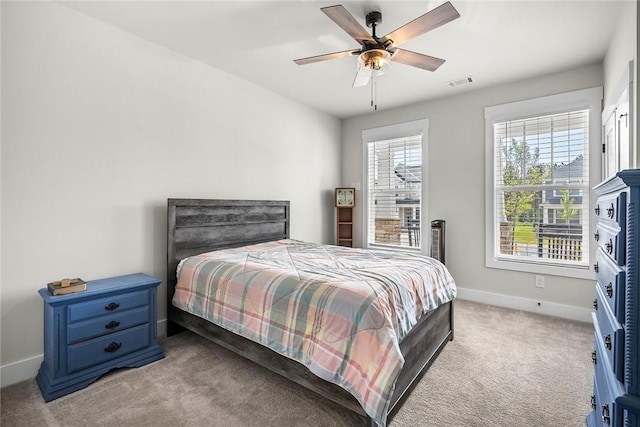 bedroom featuring visible vents, baseboards, carpet floors, and ceiling fan