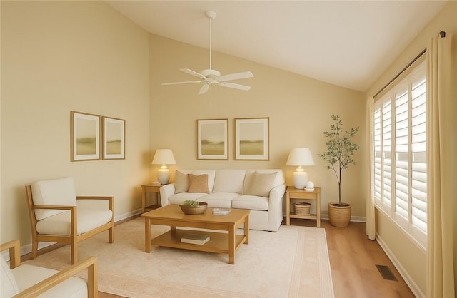 living area with visible vents, baseboards, light wood-type flooring, a ceiling fan, and vaulted ceiling