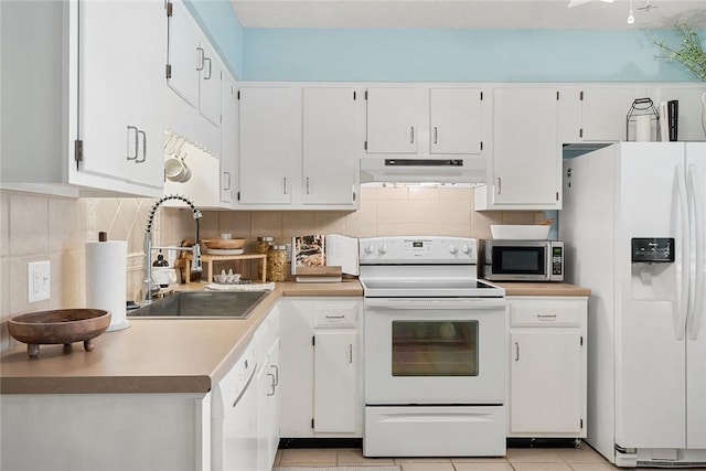 kitchen with a sink, white cabinets, under cabinet range hood, and white appliances