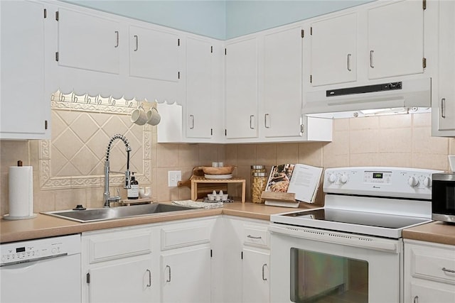 kitchen with a sink, tasteful backsplash, under cabinet range hood, and white appliances