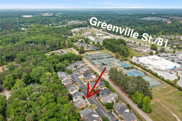 birds eye view of property featuring a forest view and a residential view