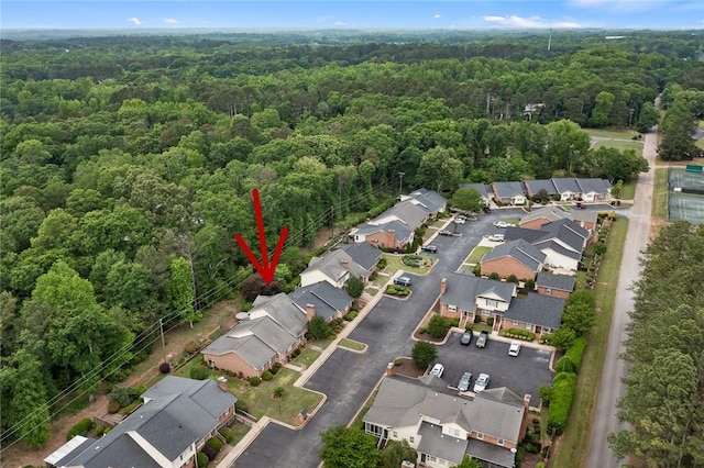 aerial view featuring a forest view and a residential view