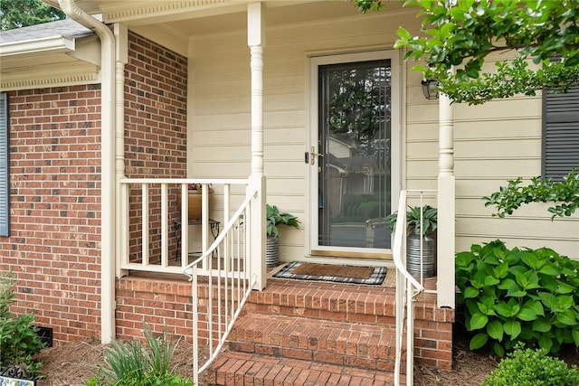 entrance to property featuring brick siding
