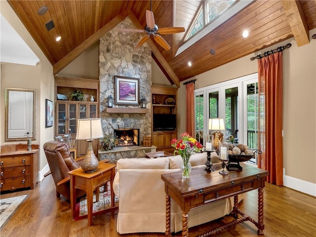 living room featuring a ceiling fan, baseboards, wooden ceiling, and lofted ceiling