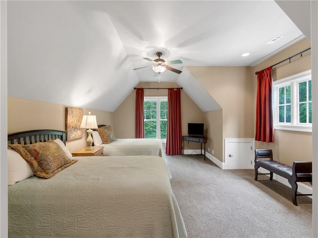 carpeted bedroom featuring visible vents, a ceiling fan, baseboards, and lofted ceiling