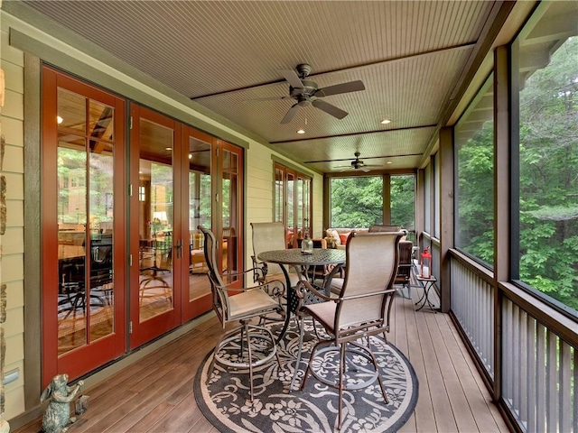 sunroom / solarium with a ceiling fan and french doors