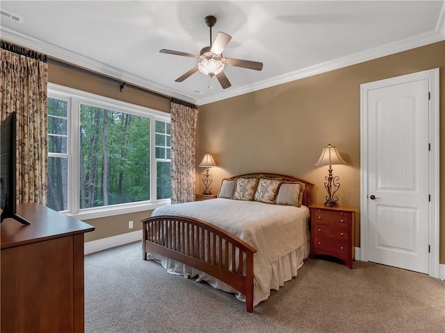 bedroom with carpet floors, baseboards, crown molding, and visible vents