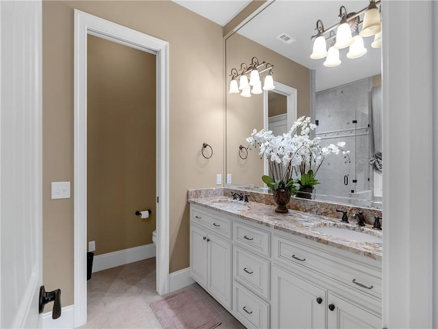 bathroom featuring visible vents, double vanity, an inviting chandelier, toilet, and a shower stall