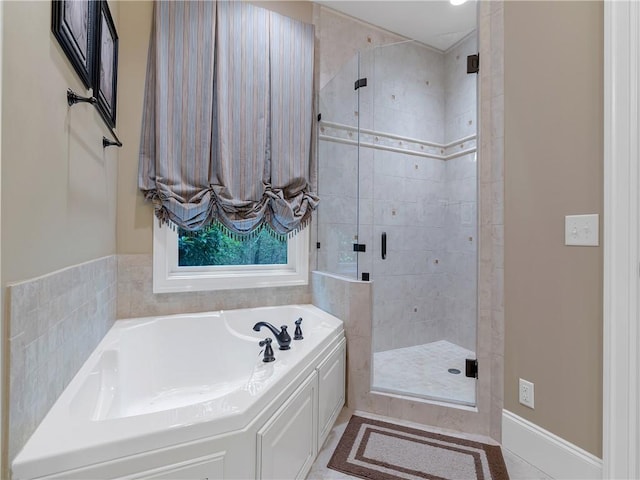 full bath with a shower stall and a bath