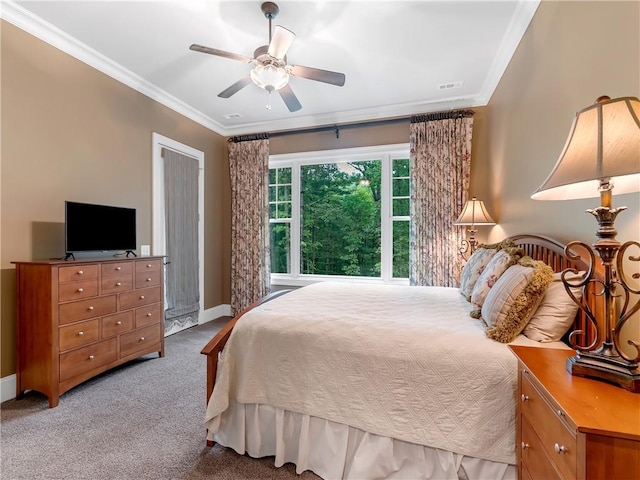 bedroom with carpet floors, a ceiling fan, baseboards, visible vents, and ornamental molding