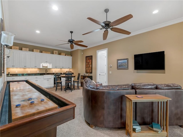 living area featuring crown molding, recessed lighting, ceiling fan, and light carpet
