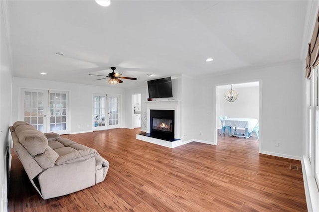 living room featuring recessed lighting, baseboards, and french doors