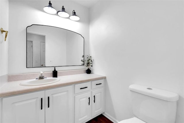 bathroom with toilet and vanity