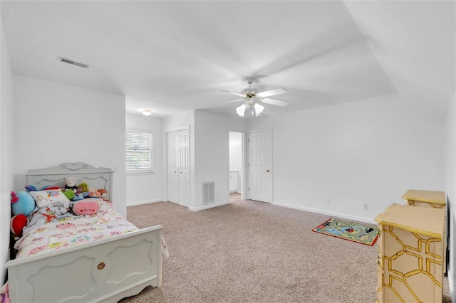 bedroom featuring baseboards, light carpet, a closet, and visible vents
