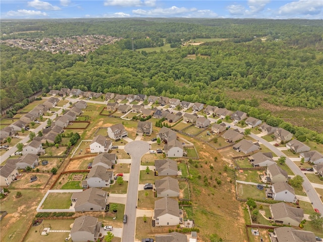 drone / aerial view with a residential view and a wooded view