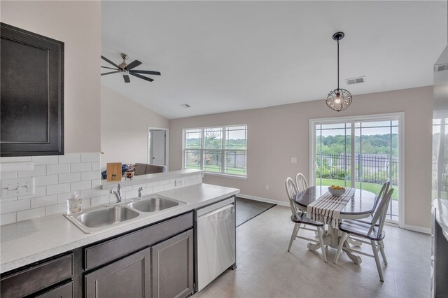 kitchen with visible vents, lofted ceiling, light countertops, a sink, and dishwasher