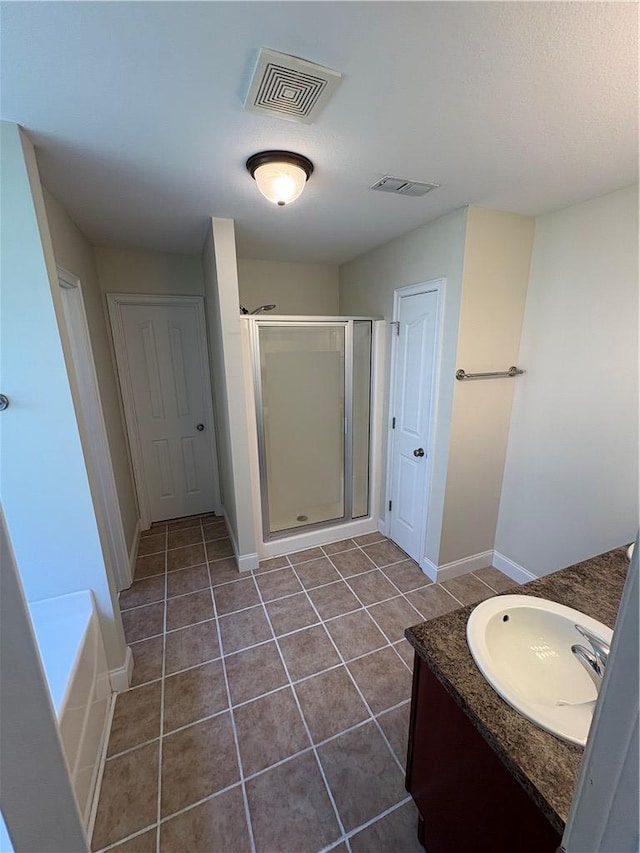 full bath featuring visible vents, a shower stall, tile patterned flooring, and vanity