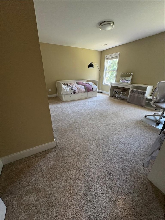 carpeted bedroom with baseboards
