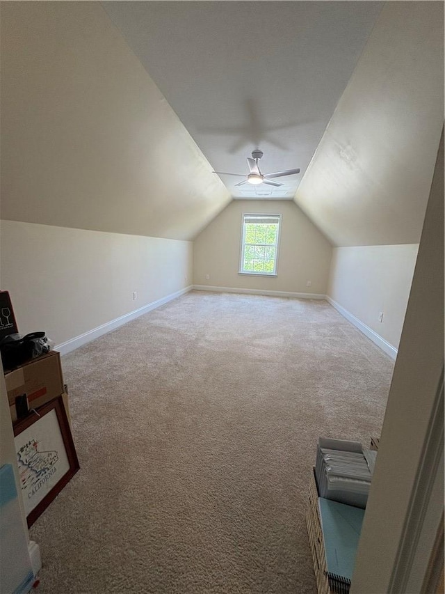 bonus room featuring baseboards, a ceiling fan, carpet floors, and lofted ceiling