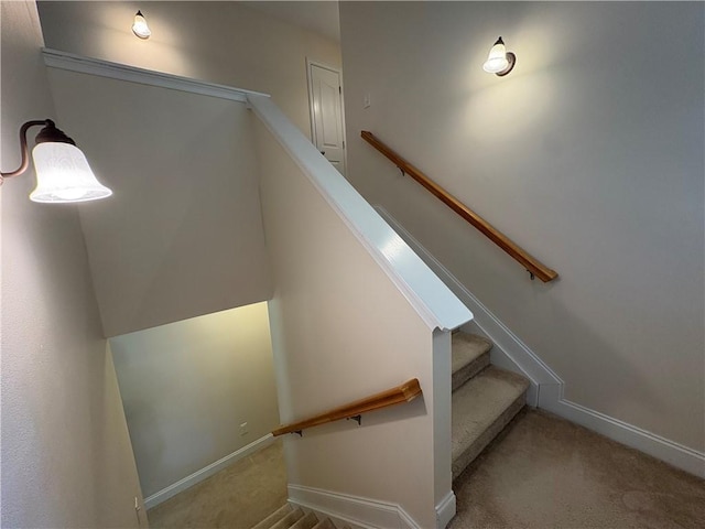 staircase with baseboards and carpet