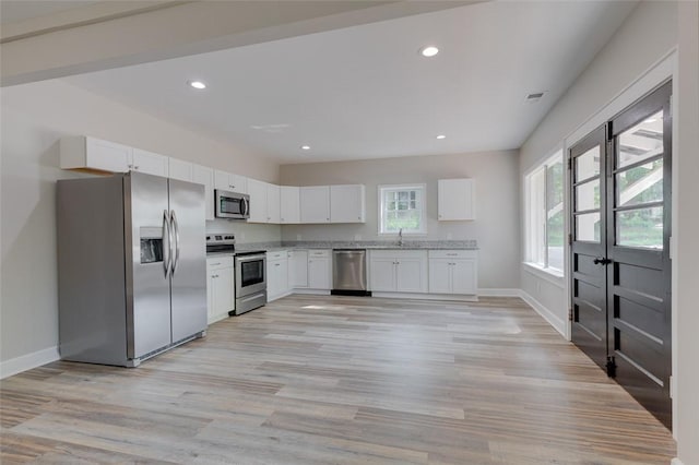 9 Dixie Ave, Liberty, SC 29657 - kitchen with stainless steel appliances, baseboards, white cabinetry, and a sink