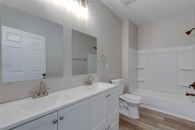9 Dixie Ave, Liberty, SC 29657 - full bathroom featuring a sink, double vanity, toilet, and wood finished floors