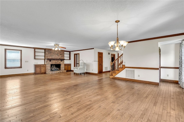 2018 Concord Rd, Anderson, SC 29621 - unfurnished living room featuring crown molding, baseboards, wood finished floors, and ceiling fan with notable chandelier