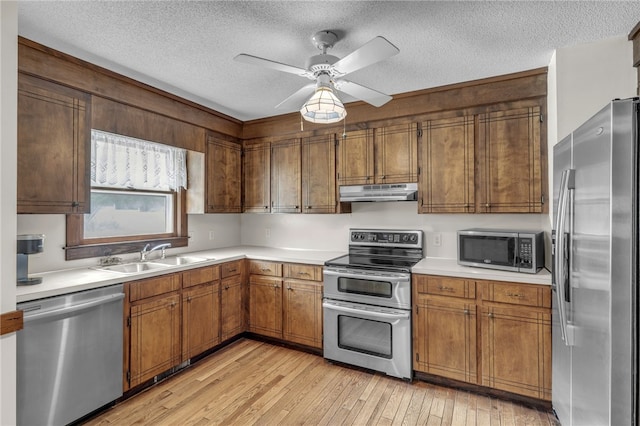 2018 Concord Rd, Anderson, SC 29621 - kitchen with a textured ceiling, a sink, light countertops, under cabinet range hood, and stainless steel appliances