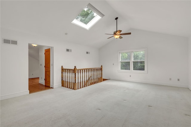 2018 Concord Rd, Anderson, SC 29621 - spare room featuring visible vents, carpet flooring, a ceiling fan, and vaulted ceiling with skylight