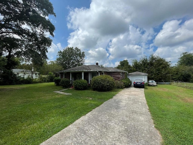view of front of house with fence, driveway, a chimney, and a front lawn