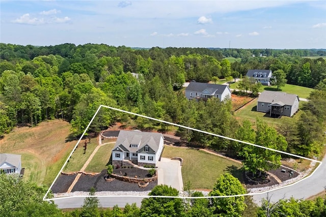 birds eye view of property with a view of trees