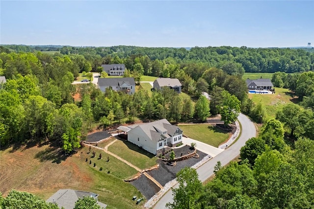 drone / aerial view featuring a forest view