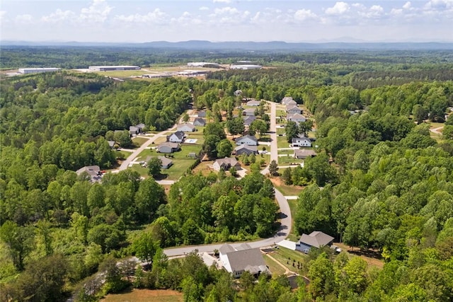 aerial view featuring a wooded view