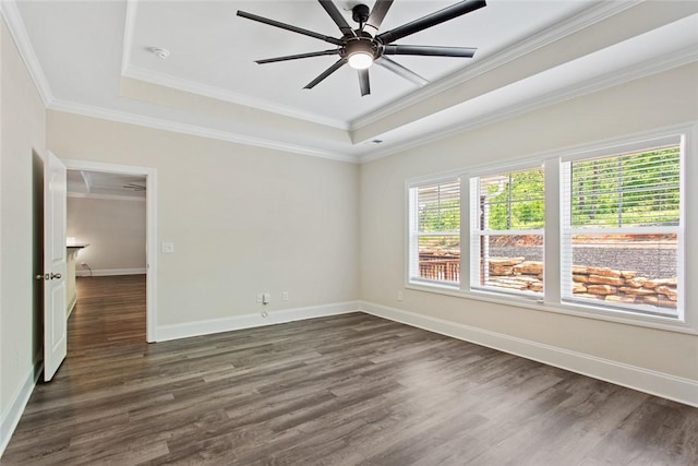 unfurnished bedroom featuring ornamental molding, a raised ceiling, and dark wood-type flooring