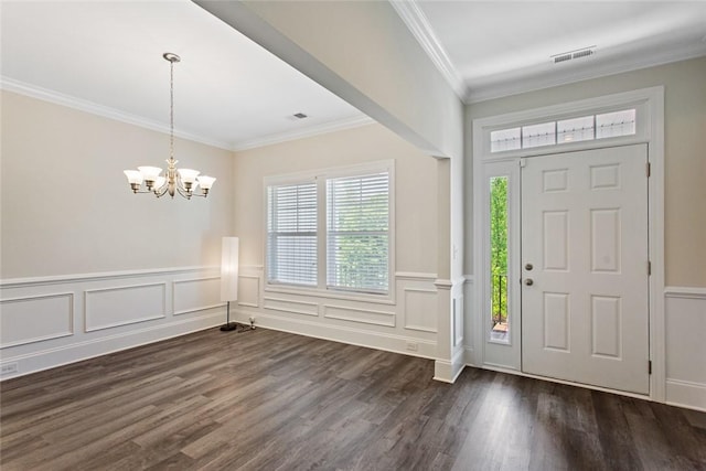 entrance foyer with crown molding, visible vents, dark wood finished floors, and an inviting chandelier