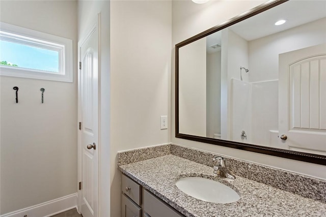 bathroom with vanity and a shower