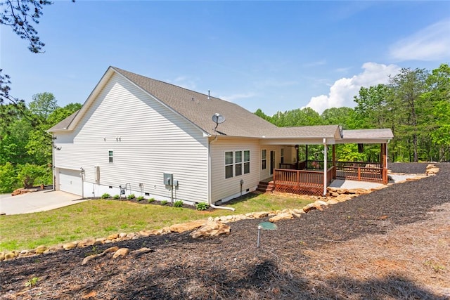 view of property exterior with a garage, a wooden deck, crawl space, concrete driveway, and a lawn