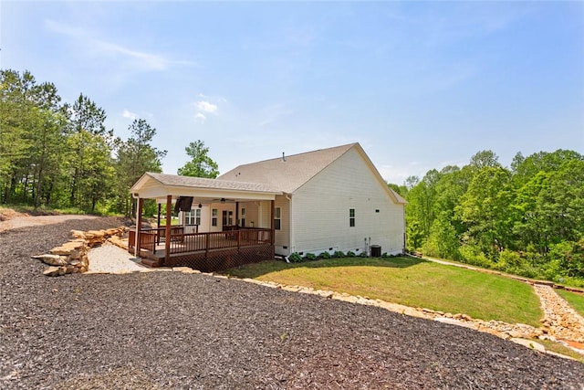 rear view of house featuring ceiling fan, a deck, crawl space, a lawn, and central air condition unit