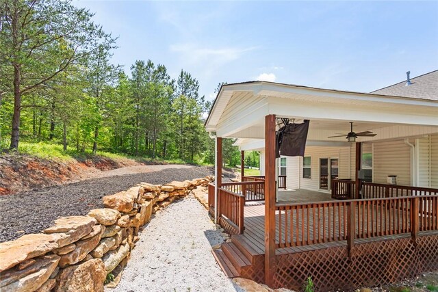 wooden terrace featuring ceiling fan