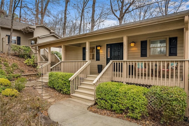 view of front facade featuring stairs and covered porch